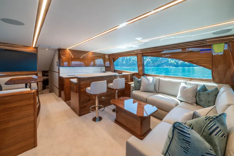 Slide: The Image of Luxurious interior of 2026 Viking 64 Convertible yacht with elegant wood finishes and plush seating. - 1