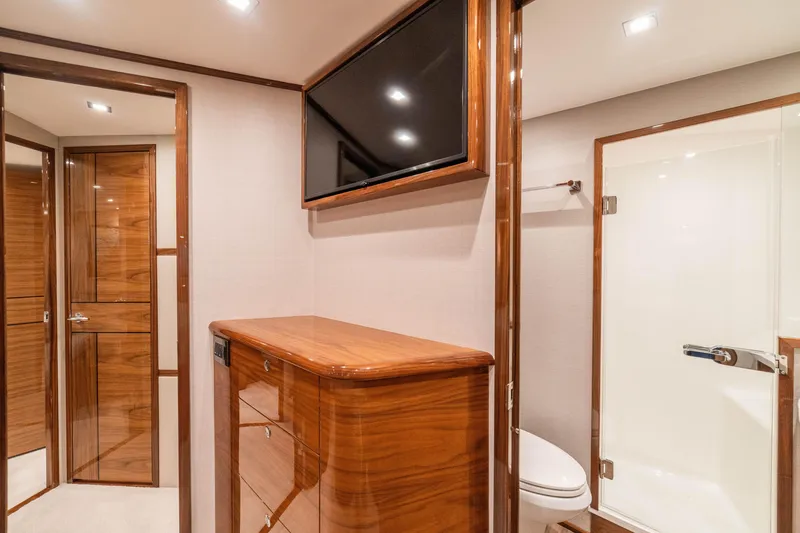 Slide: The Image of Luxurious interior of 2026 Viking 64 Convertible yacht with wood finishes and modern amenities. - 11