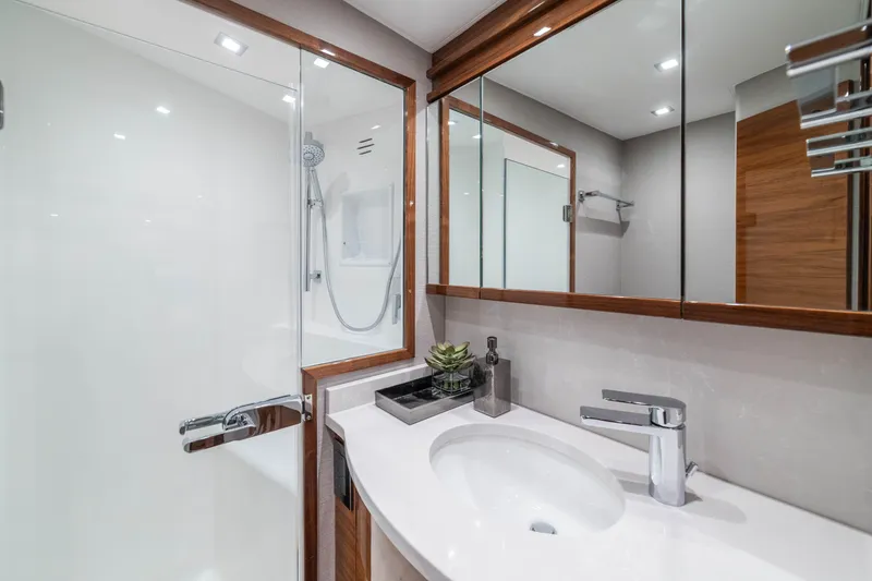 Slide: The Image of Luxurious bathroom in 2026 Viking 64 Convertible yacht with modern fixtures and elegant design. - 12