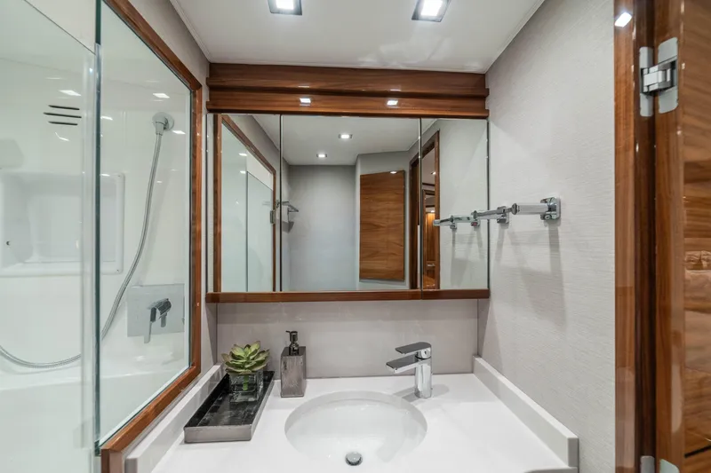 Slide: The Image of Luxurious bathroom in 2026 Viking 64 Convertible yacht with modern fixtures and elegant design. - 13
