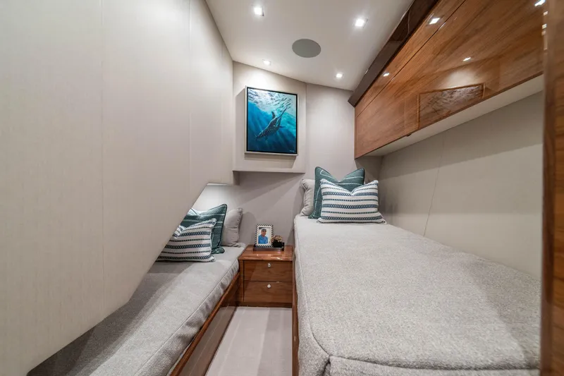 Slide: The Image of Luxurious cabin interior of 2026 Viking 64 Convertible yacht with elegant decor and cozy bedding. - 14