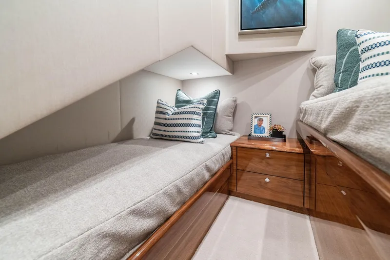 Slide: The Image of Luxurious interior of 2026 Viking 64 Convertible yacht cabin with cozy bedding and decor. - 15