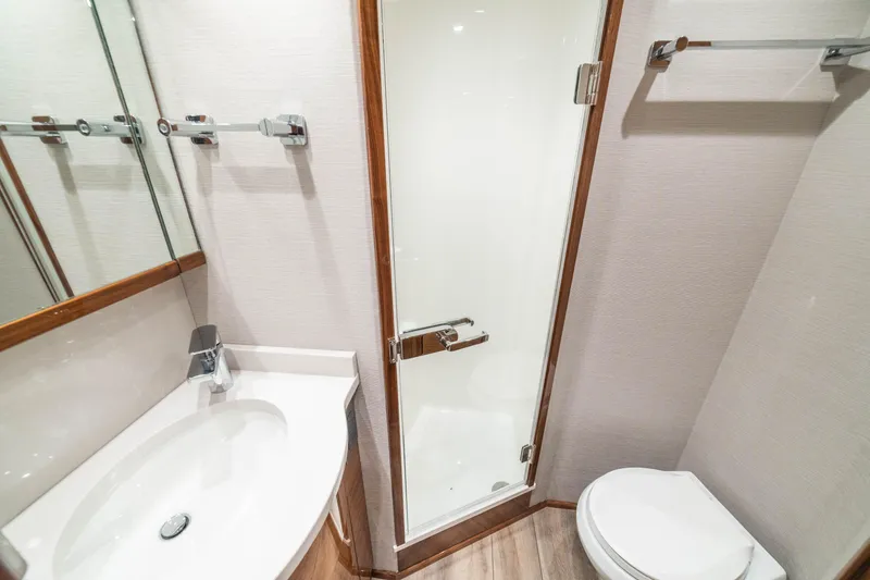 Slide: The Image of Luxurious bathroom in 2026 Viking 64 Convertible yacht with modern fixtures and elegant design. - 18