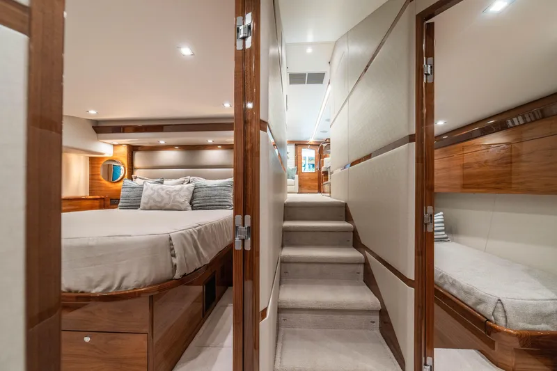 Slide: The Image of Luxurious interior of 2026 Viking 64 Convertible yacht with elegant wood finishes. - 21