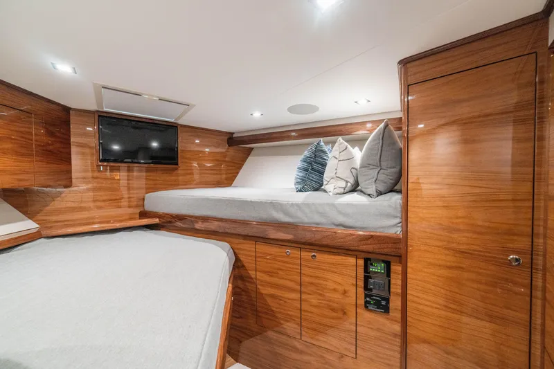 Slide: The Image of Luxurious 2026 Viking 64 Convertible yacht cabin with wood finish and modern amenities. - 23