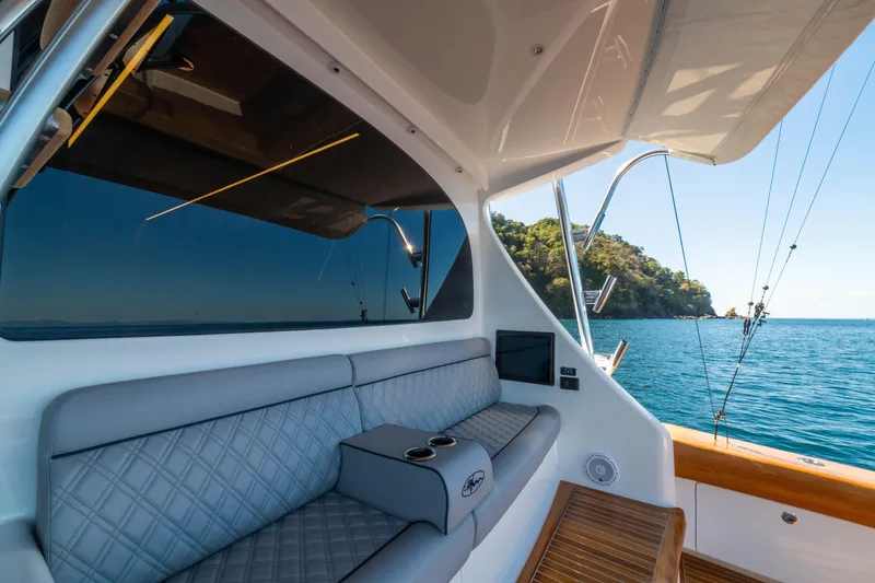 Slide: The Image of 2026 Viking 64 Convertible yacht interior with ocean view and luxurious seating. - 28