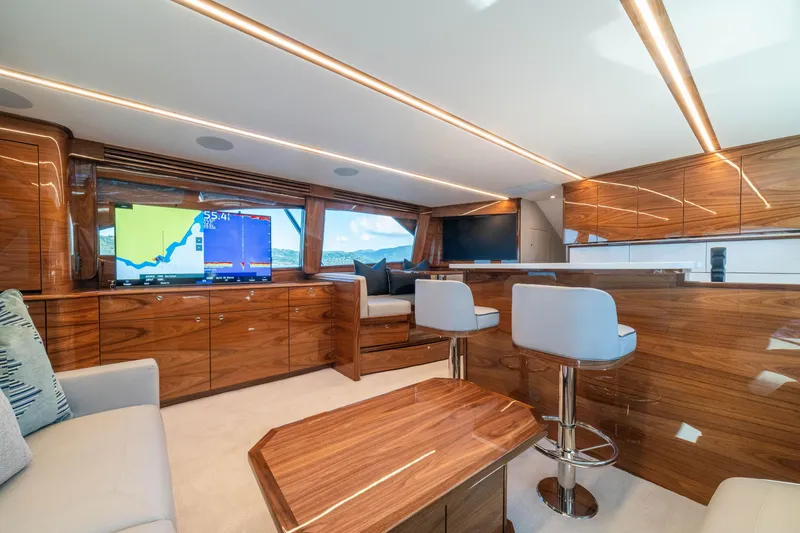 Slide: The Image of Luxurious interior of 2026 Viking 64 Convertible yacht with modern wood finishes and seating. - 3