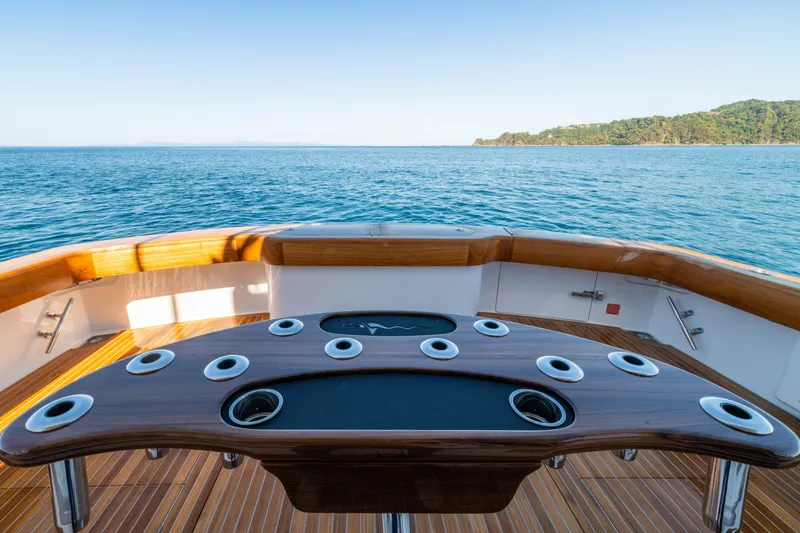 Slide: The Image of 2026 Viking 64 Convertible yacht deck with ocean view and fishing rod holders. - 30