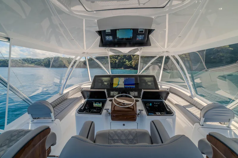 Slide: The Image of Luxurious 2026 Viking 64 Convertible yacht cockpit with advanced navigation systems. - 31