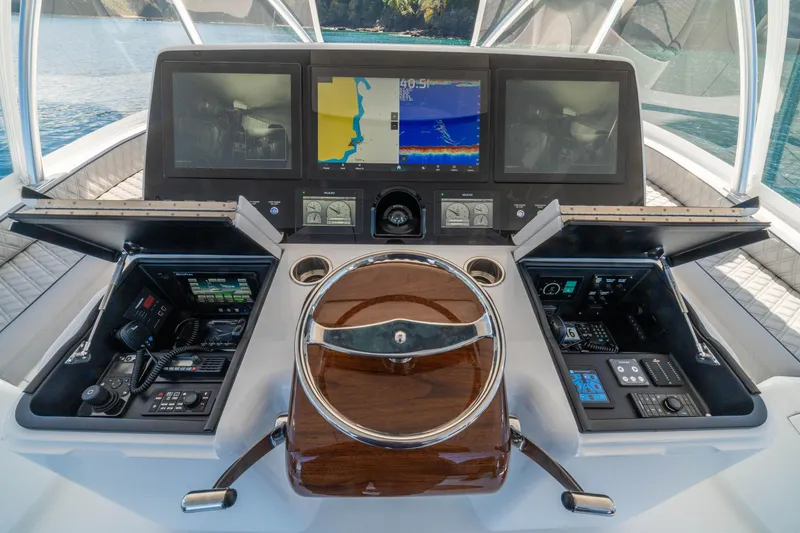Slide: The Image of Cockpit of 2026 Viking 64 Convertible yacht with advanced navigation displays and controls. - 33