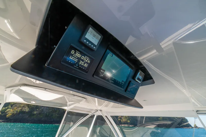 Slide: The Image of 2026 Viking 64 Convertible yacht dashboard with navigation displays and ocean view. - 34