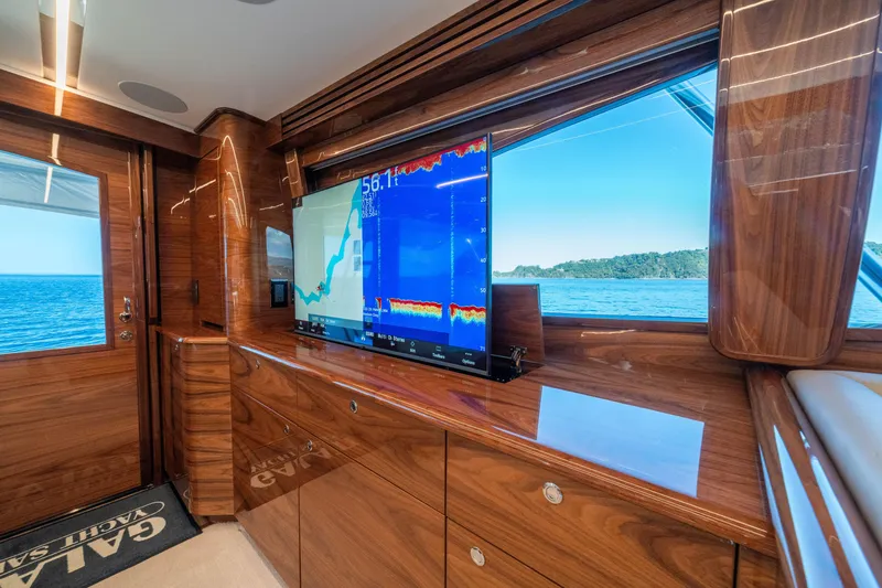 Slide: The Image of Luxurious interior of 2026 Viking 64 Convertible yacht with navigation display and ocean view. - 4