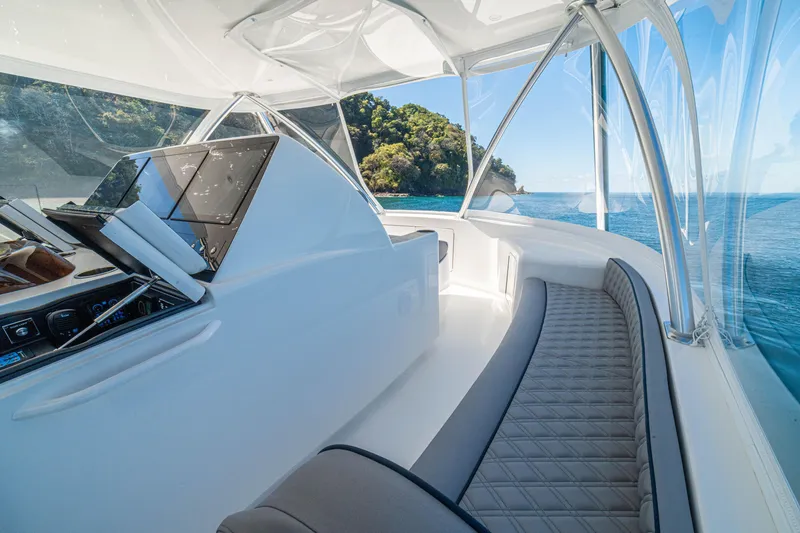 Slide: The Image of Interior of 2026 Viking 64 Convertible yacht with ocean view and luxurious seating. - 41