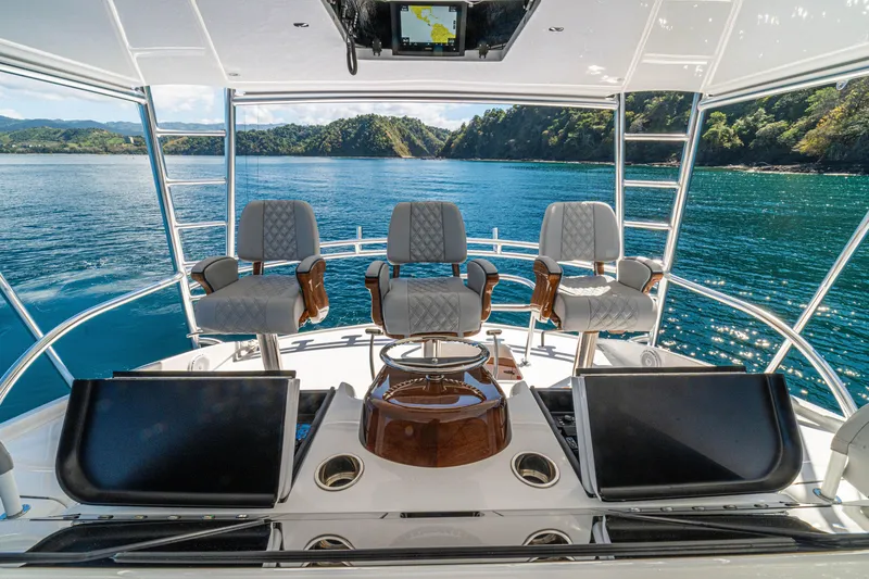 Slide: The Image of Luxurious helm of 2026 Viking 64 Convertible yacht with scenic ocean view. - 42