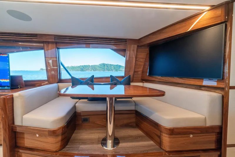 Slide: The Image of Luxurious interior of 2026 Viking 64 Convertible yacht with elegant wood finish and seating area. - 5