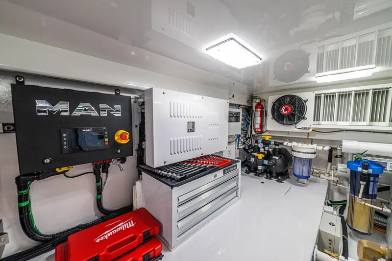 Slide: The Image of Engine room of 2026 Viking 64 Convertible yacht with tools and equipment. - 53