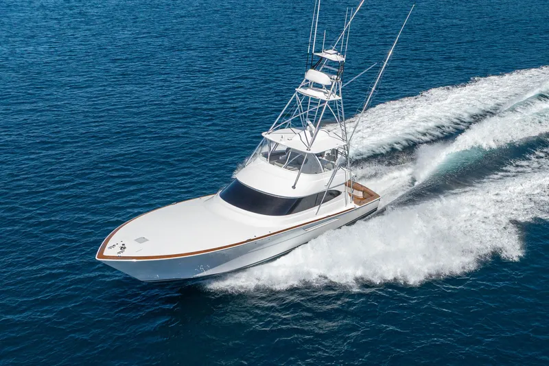 Slide: The Image of 2026 Viking 64 Convertible yacht cruising on open blue water. - 59