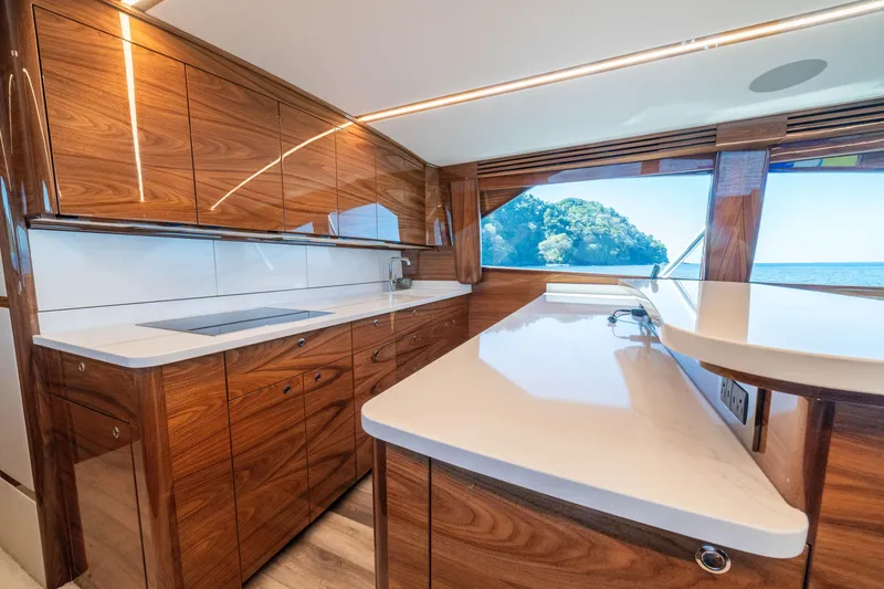 Slide: The Image of Luxurious kitchen interior of 2026 Viking 64 Convertible yacht with ocean view. - 7