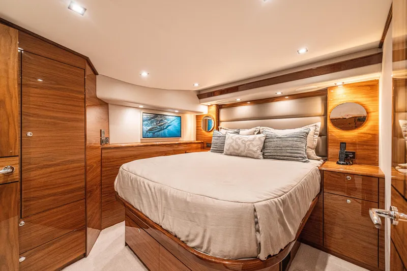 Slide: The Image of Luxurious 2026 Viking 64 Convertible yacht bedroom with elegant wood finishes and modern lighting. - 8