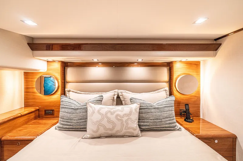Slide: The Image of Luxurious bedroom interior of 2026 Viking 64 Convertible yacht with elegant wood accents. - 9