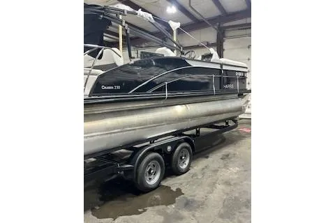 Slide: The Image of 2023 Harris Cruiser 230 pontoon boat on trailer in indoor storage facility. - 14