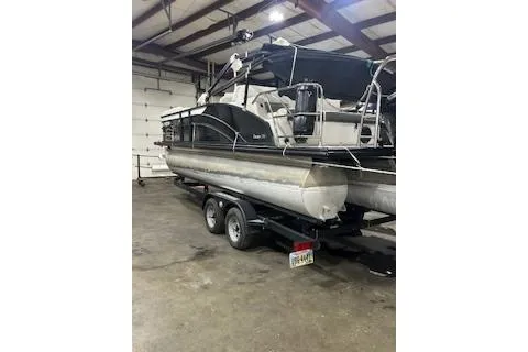 Slide: The Image of 2023 Harris Cruiser 230 pontoon boat in a garage on a trailer. - 15