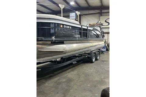 Slide: The Image of 2023 Harris Cruiser 230 pontoon boat in indoor storage facility. - 16