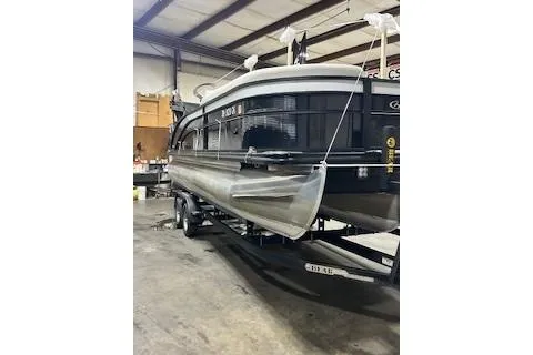 Slide: The Image of 2023 Harris Cruiser 230 pontoon boat in a warehouse setting. - 17