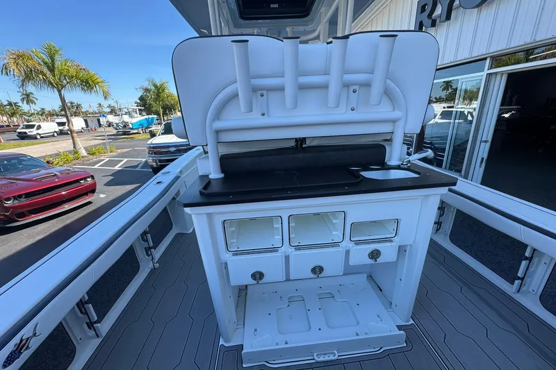 Slide: The Image of 2024 Crevalle 26 HCO boat interior with fishing rod holders and storage compartments. - 14
