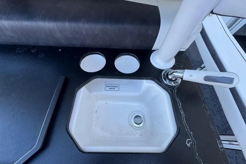 Slide: The Image of 2024 Crevalle 26 HCO boat sink with non-potable water label and faucet. - 15