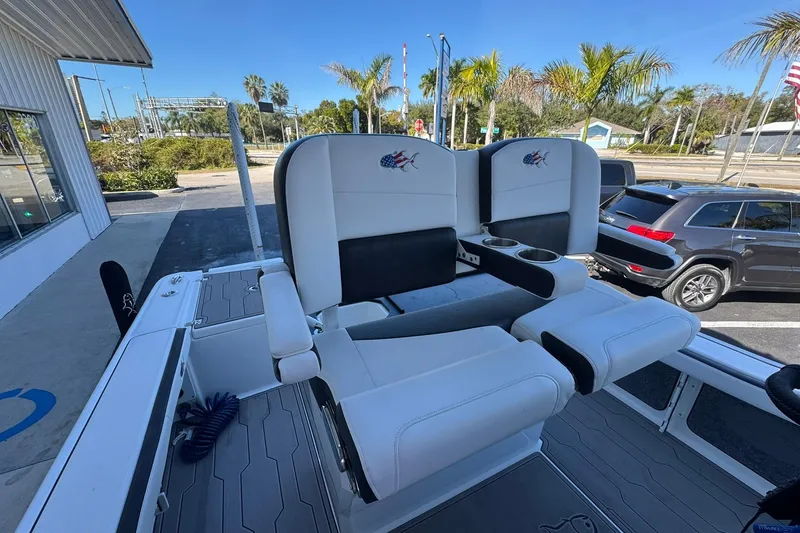 Slide: The Image of 2024 Crevalle 26 HCO boat interior with dual white seats and cup holders. - 18
