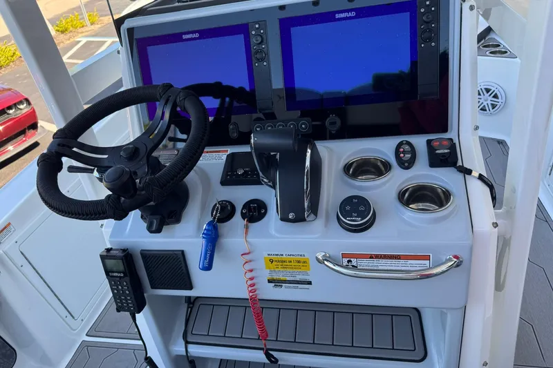 Slide: The Image of 2024 Crevalle 26 HCO boat console with dual Simrad displays and steering wheel. - 19