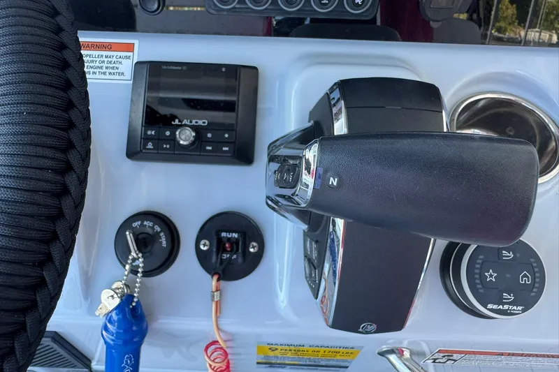 Slide: The Image of 2024 Crevalle 26 HCO boat dashboard with controls and JL Audio system. - 23