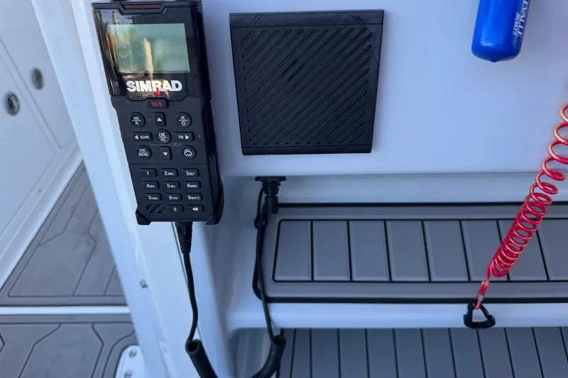 Slide: The Image of Simrad radio on 2024 Crevalle 26 HCO boat dashboard with safety equipment. - 25