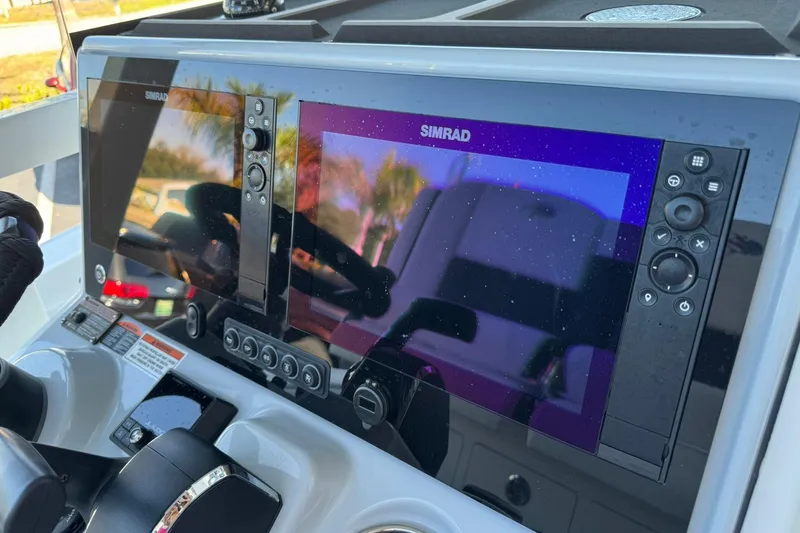Slide: The Image of 2024 Crevalle 26 HCO boat dashboard with dual Simrad displays. - 26