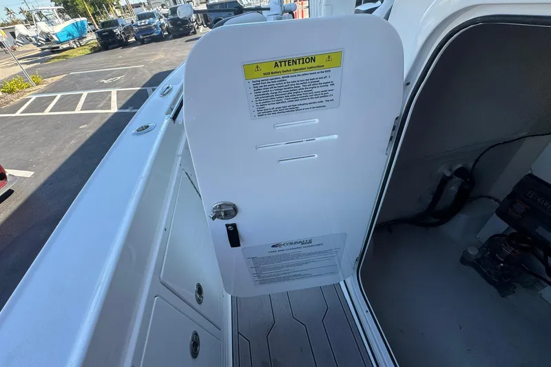 Slide: The Image of 2024 Crevalle 26 HCO boat interior with open storage compartment and safety instructions. - 30