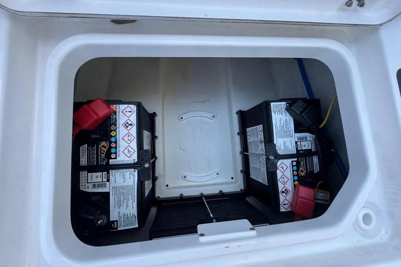Slide: The Image of Battery compartment of 2024 Crevalle 26 HCO boat, featuring dual batteries. - 34