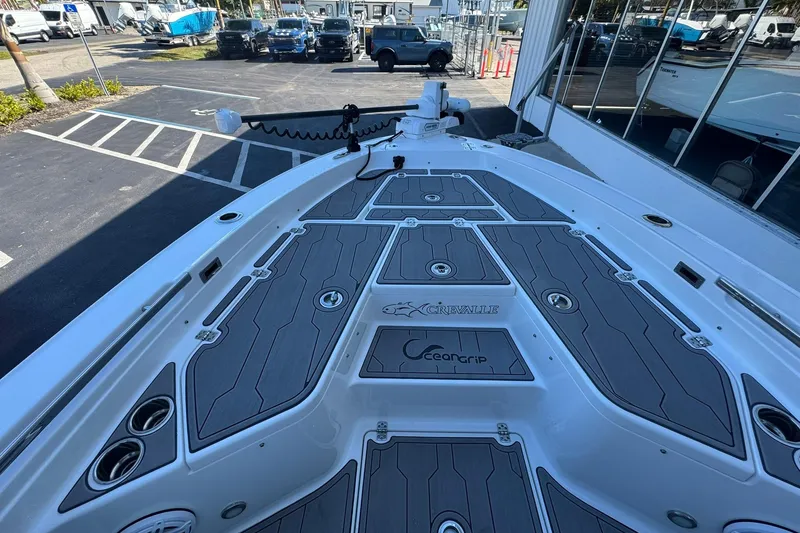 Slide: The Image of 2024 Crevalle 26 HCO boat deck with OceanGrip flooring in a parking lot setting. - 37