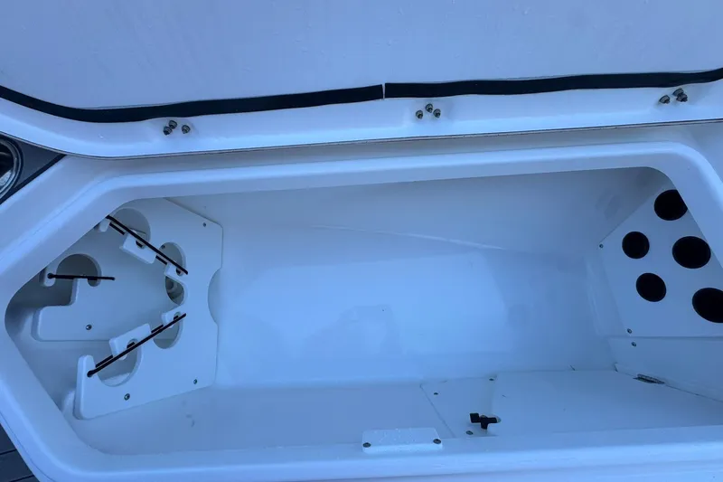 Slide: The Image of 2024 Crevalle 26 HCO boat storage compartment with rod holders and cup holders. - 39