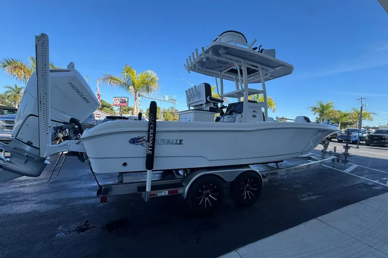 Slide: The Image of 2024 Crevalle 26 HCO boat on trailer, parked outdoors with palm trees in background. - 5