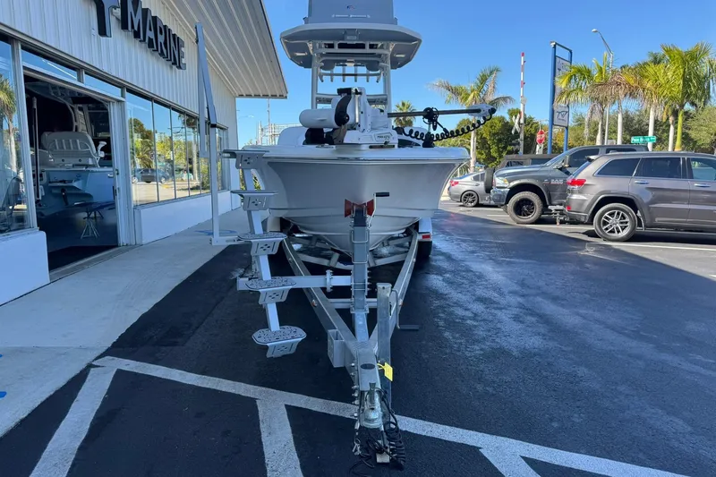 Slide: The Image of 2024 Crevalle 26 HCO boat on trailer outside marine dealership. - 6