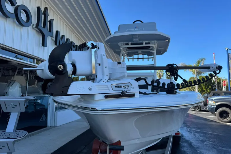 Slide: The Image of 2024 Crevalle 26 HCO boat with Minn Kota trolling motor at a marine dealership. - 7