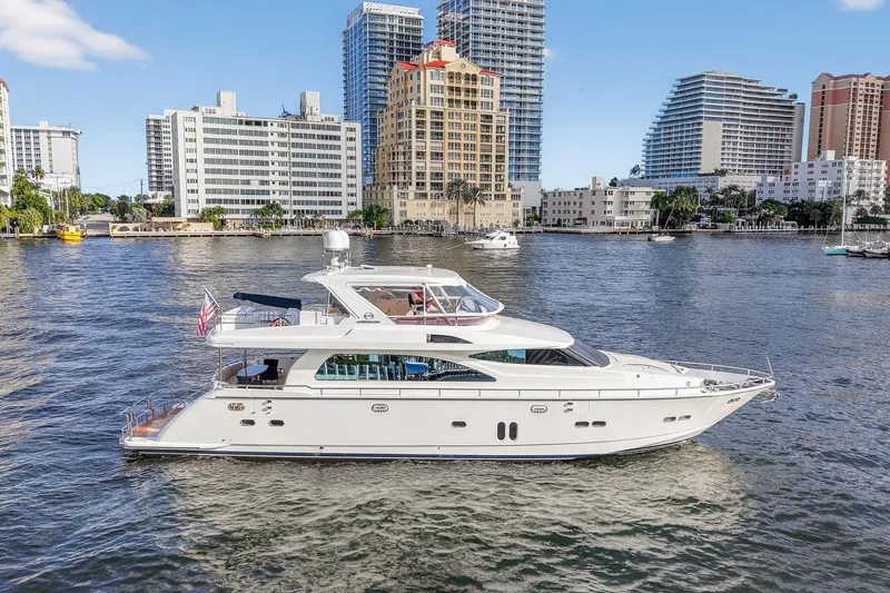 The Image of Luxurious 2009 Horizon Flybridge yacht cruising near urban waterfront skyline. - 1