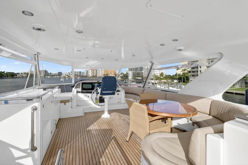 Slide: The Image of Luxurious 2009 Horizon Flybridge yacht interior with seating and helm, overlooking waterfront views. - 10