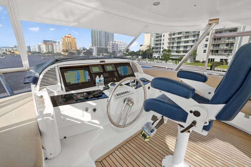 Slide: The Image of 2009 Horizon Flybridge yacht helm with blue captain's chair and navigation screens. - 11