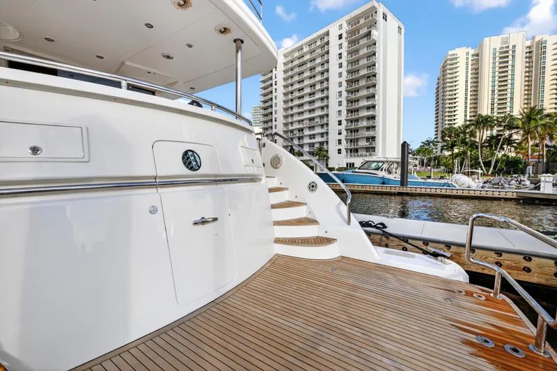 Slide: The Image of Luxury 2009 Horizon Flybridge yacht docked near modern high-rise buildings. - 13