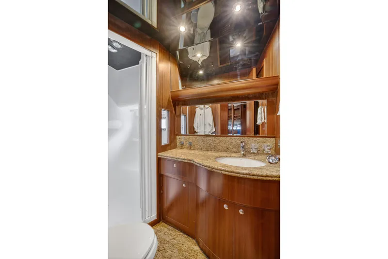 Slide: The Image of Luxurious bathroom in 2009 Horizon Flybridge yacht with wood cabinetry and granite countertop. - 27