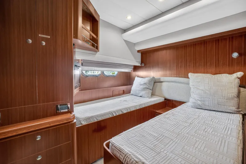 Slide: The Image of Luxurious 2009 Horizon Flybridge yacht cabin with twin beds and elegant wood finish. - 28