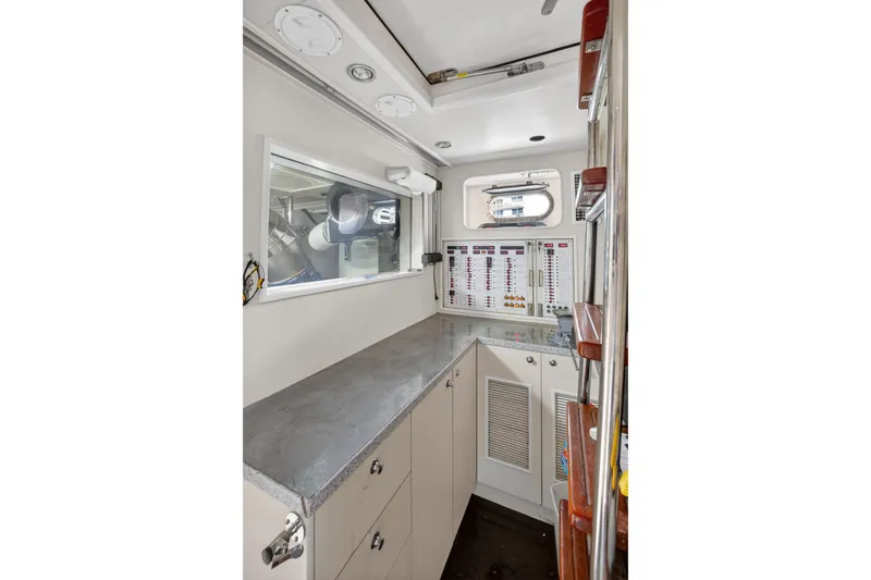 Slide: The Image of 2009 Horizon Flybridge yacht interior with control panels and storage cabinets. - 31