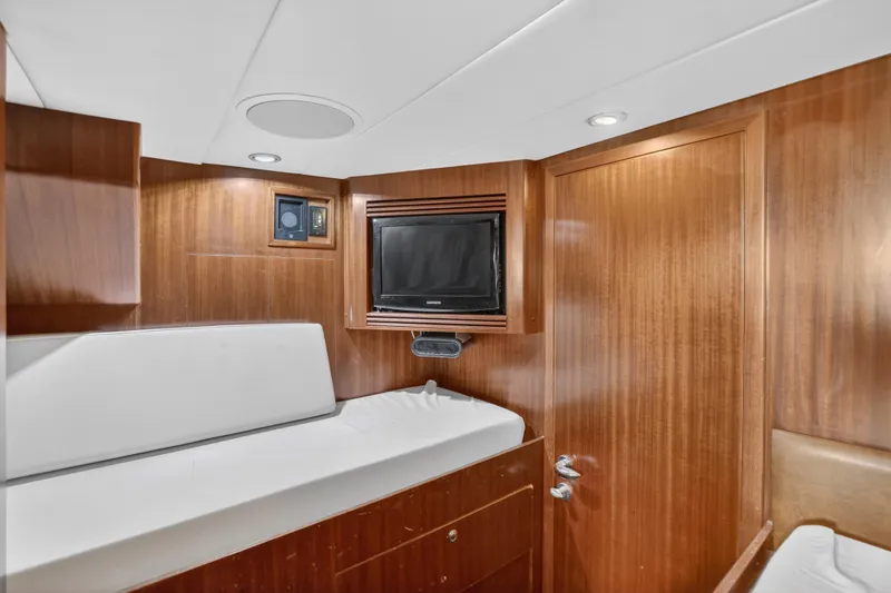 Slide: The Image of Luxurious 2009 Horizon Flybridge yacht cabin with wood paneling and TV. - 33